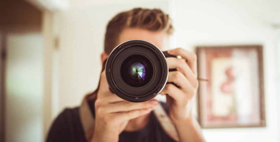 a photographer holding a camera