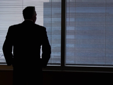 a man standing at an office window