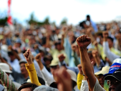 a crowd of people with raised fists