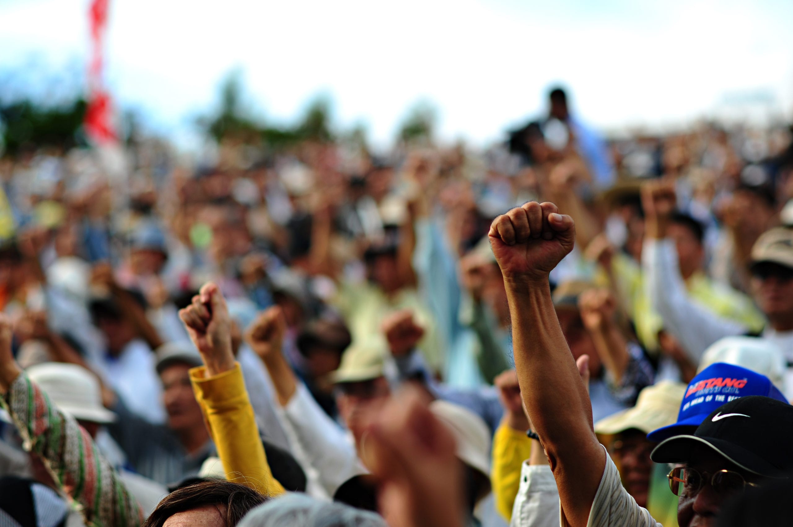 a crowd of people with raised fists