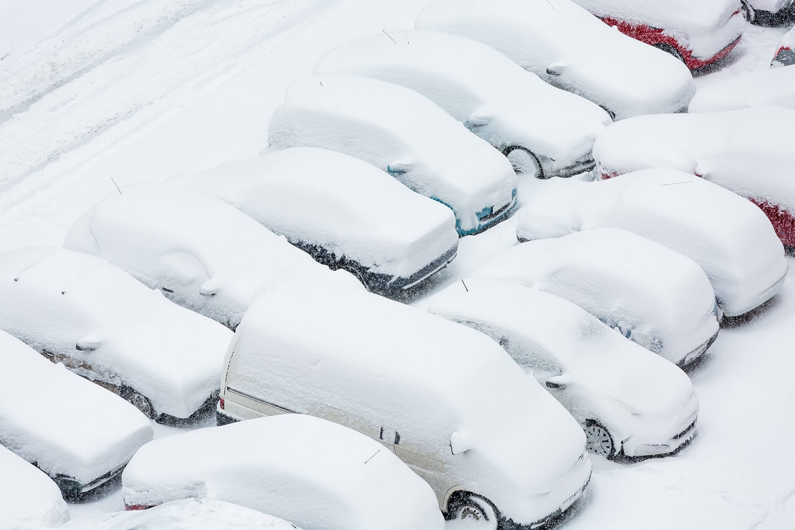 cars in a parking lot covered in snow