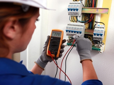 An electrical worker testing a circuit