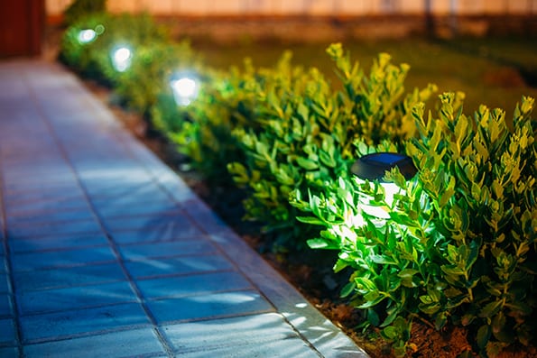 a walkway with exterior garden lighting