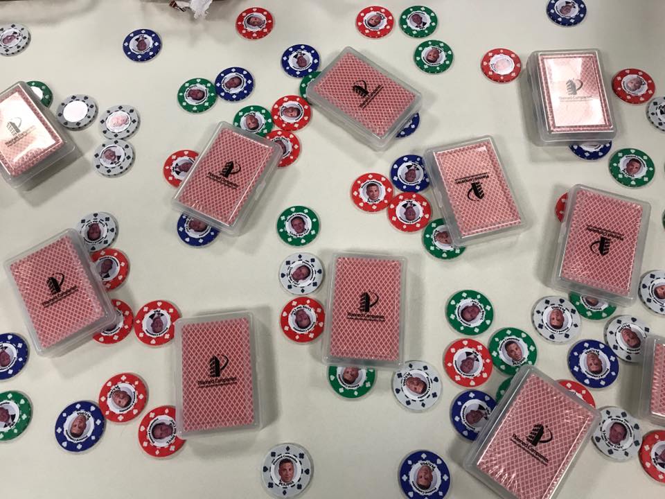 poker chips and decks of cards with the Planned Companies logo on the back of the cards