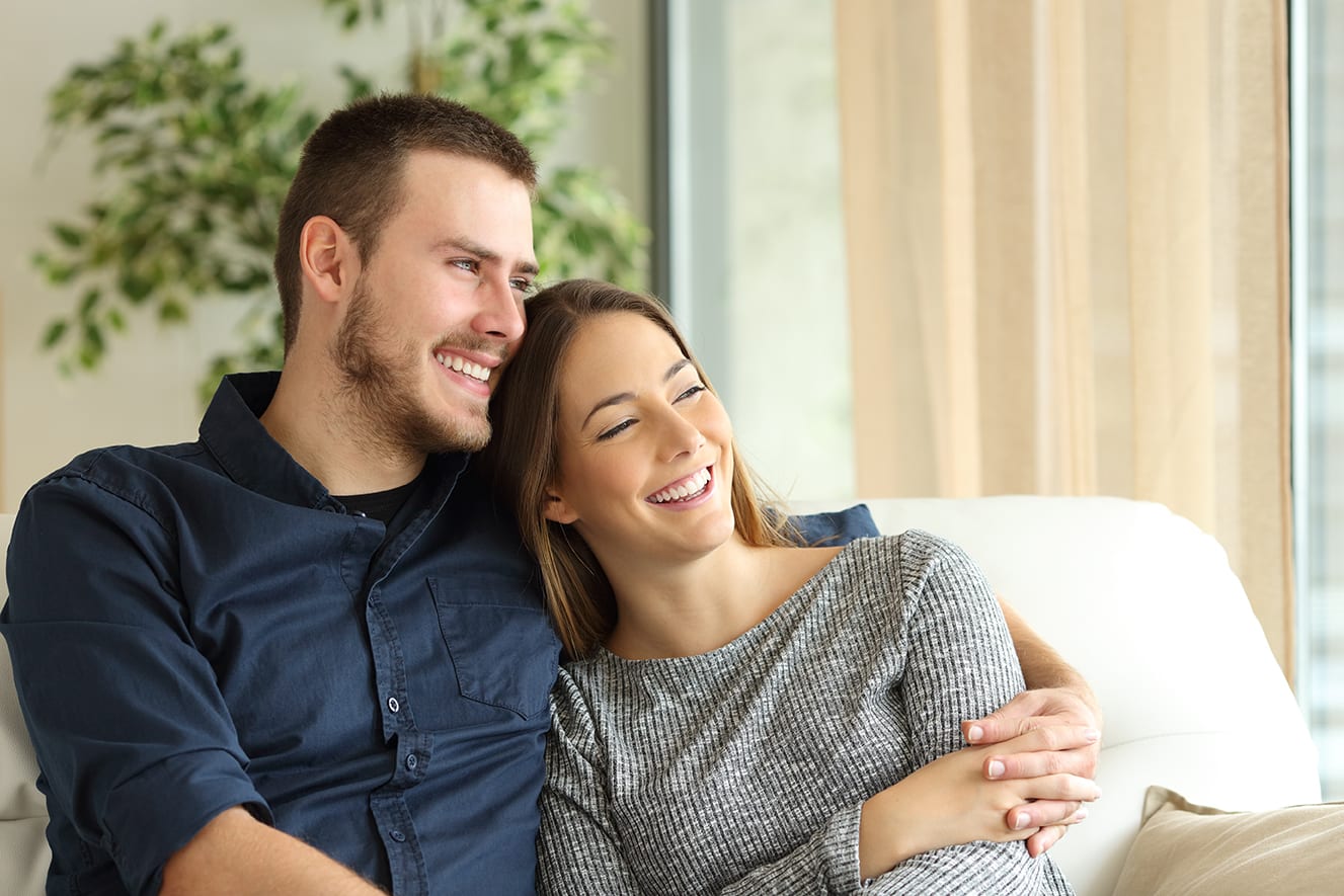 young couple sitting on a sofa