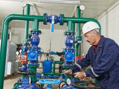 a maintenance worker adjusting a valve