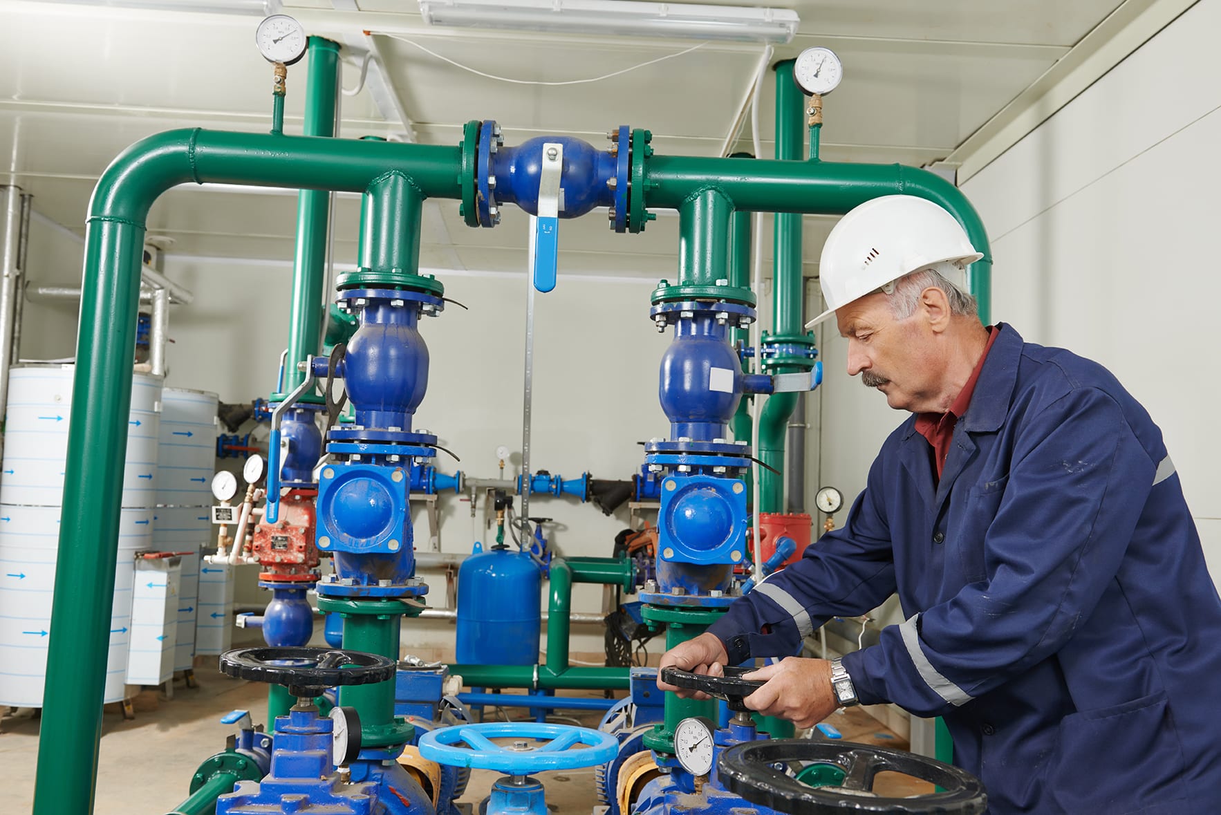 a maintenance worker adjusting a valve