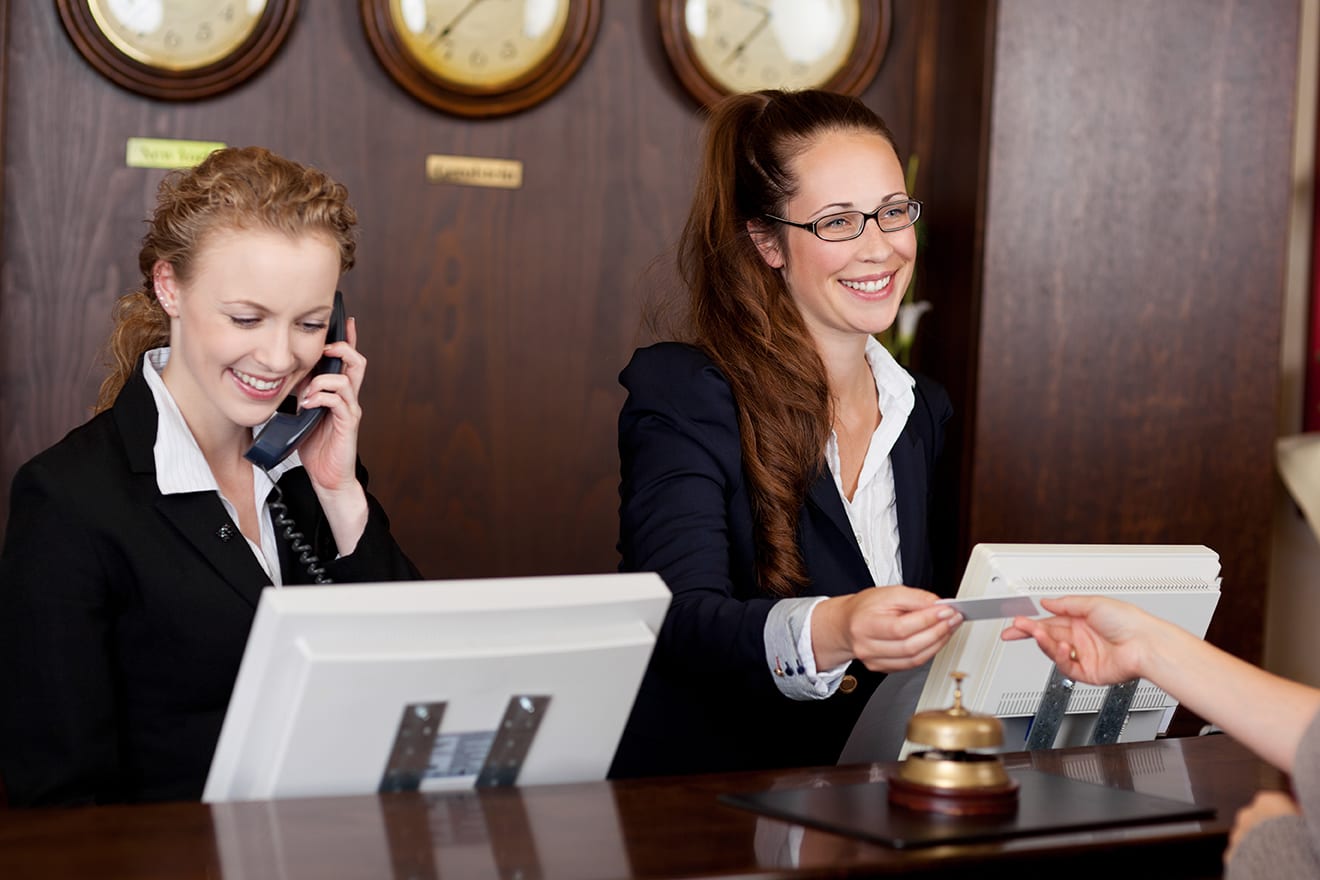 two concierge employees at their desk