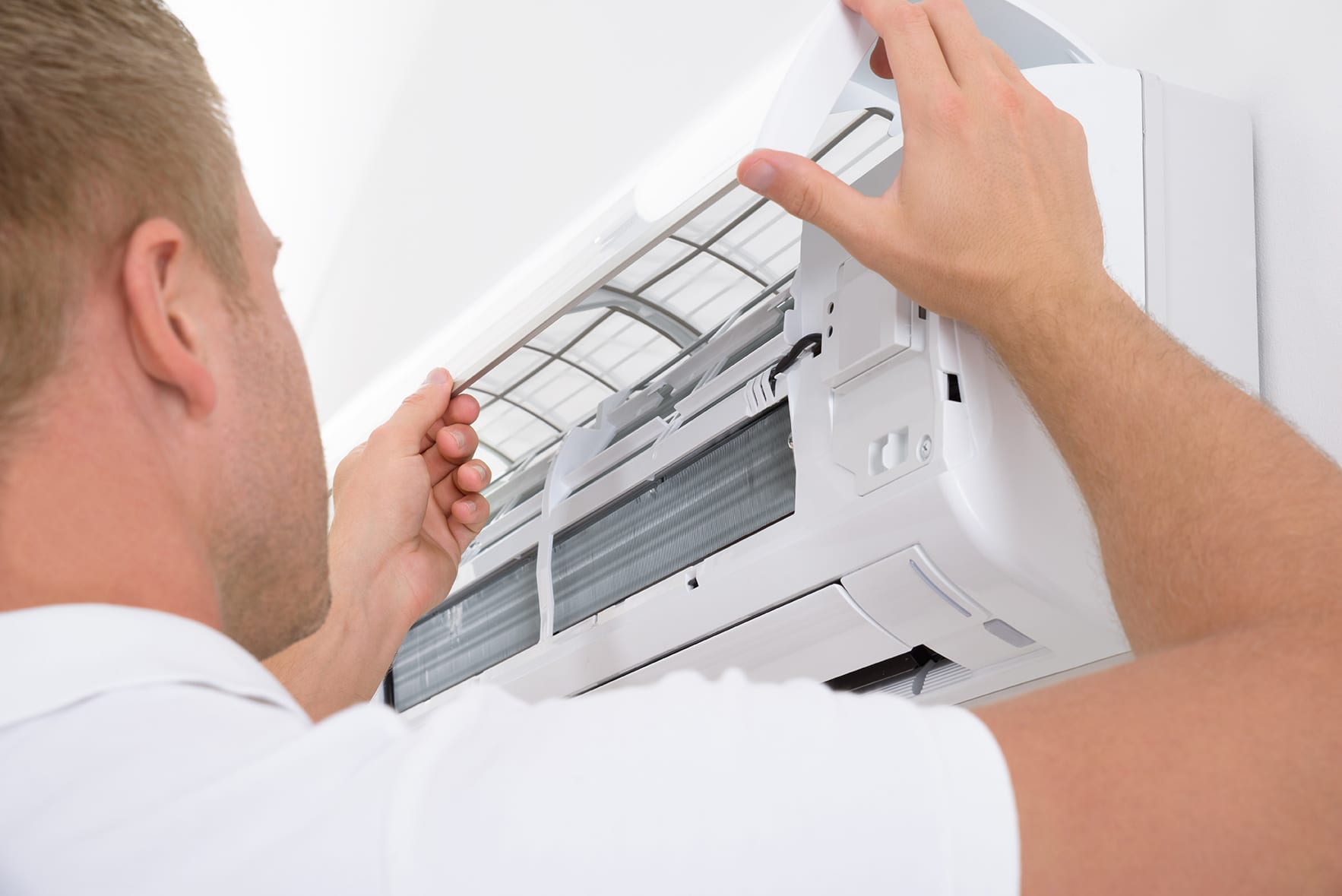 a technician repairing an air conditioner