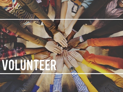 a group with their hands in a circle with the word "Volunteer" on it