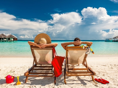 a couple relaxing on a sandy beach