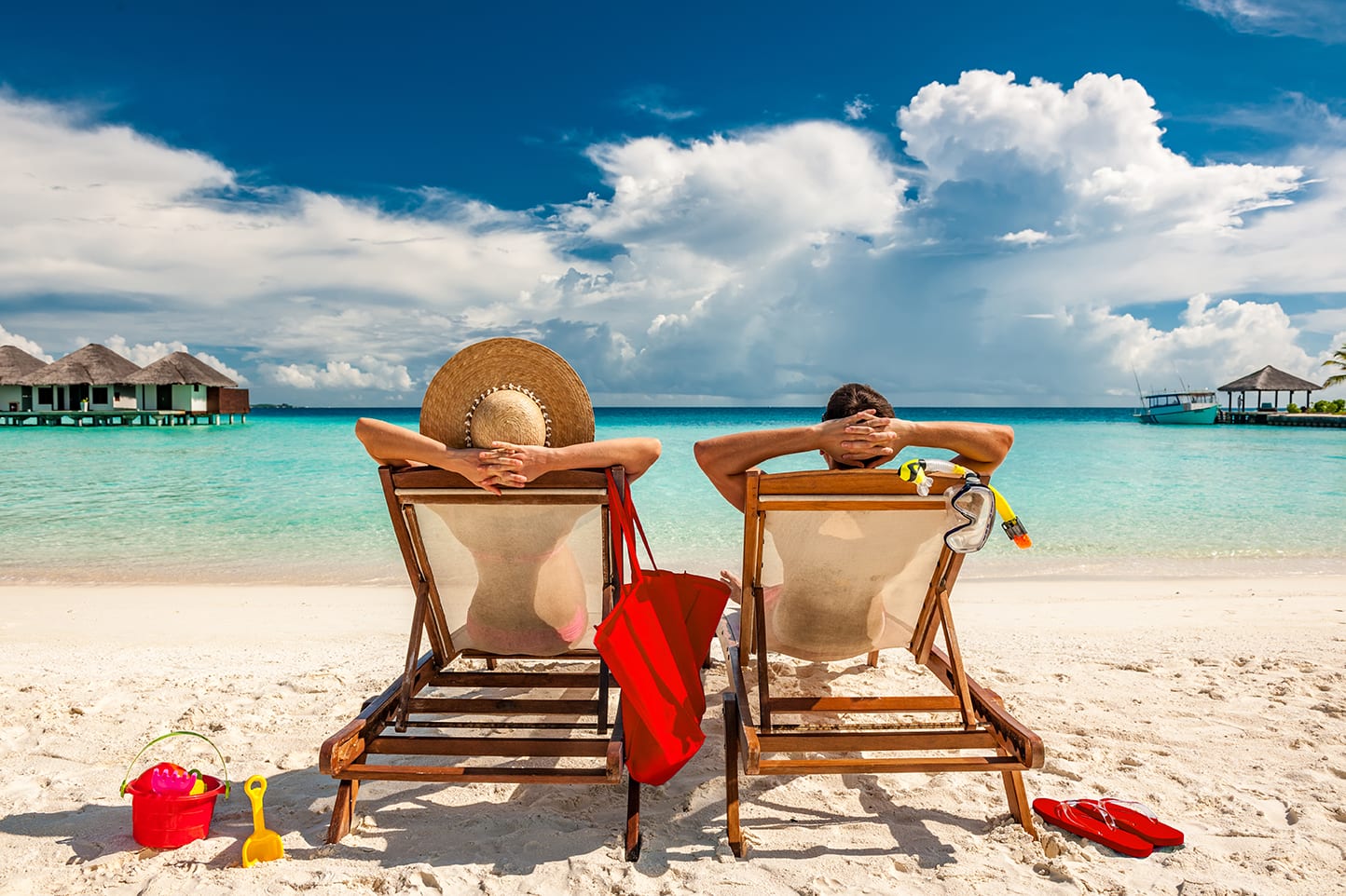 a couple relaxing on a sandy beach