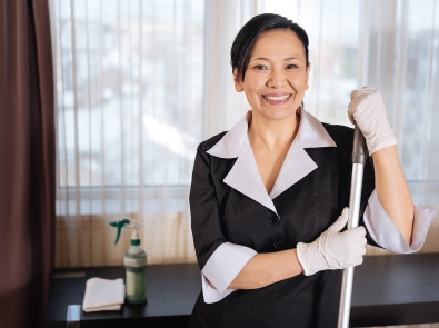 a member of the janitorial staff smiling