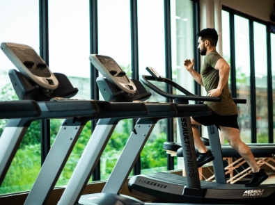 a man running on a treadmill in a gym