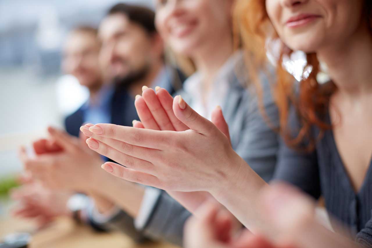 a group of people applauding