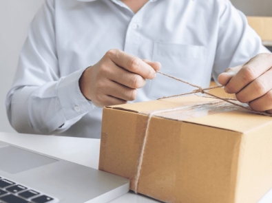 a man tying a string around a box